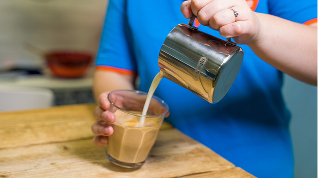 milk foam while pouring coffee