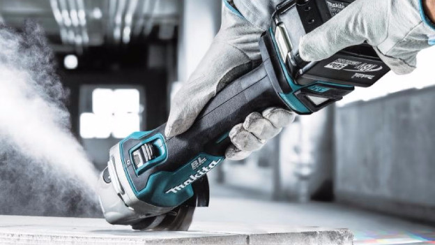 Man cuts through stone with Makita angle grinder