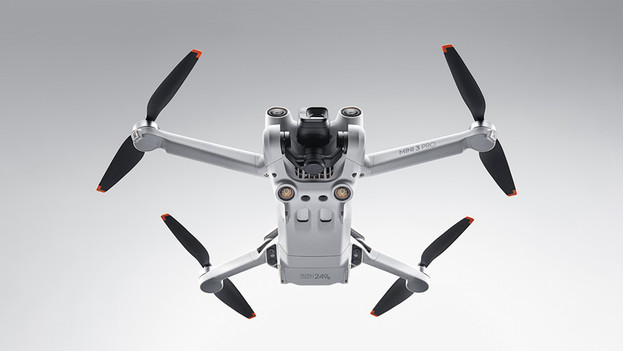 The DJI Mini 3 seen from below. The obstacle detection sensors are visible.