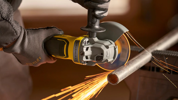 Person wears gloves against sparks of angle grinder