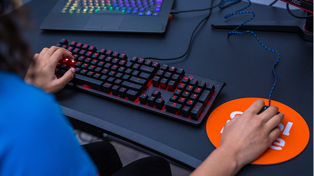 Meisje gebruikt gaming toetsenbord en muis. 