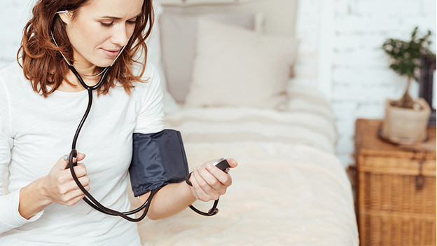 Woman with blood pressure monitor