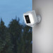 Ring Spotlight Cam Plus - White - Black + USB-C solar panel product in use