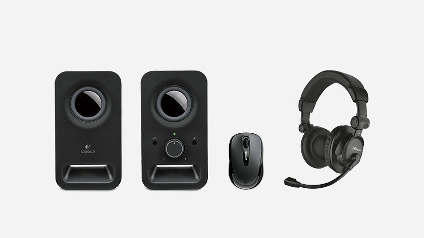 Speakers, a mouse, and a headset side by side.