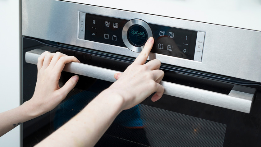 Hand next to oven display