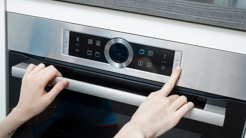 Hand that pushes button on oven