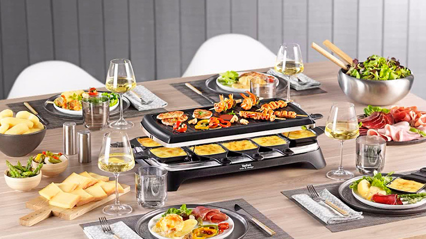 Set table with raclette grill with food