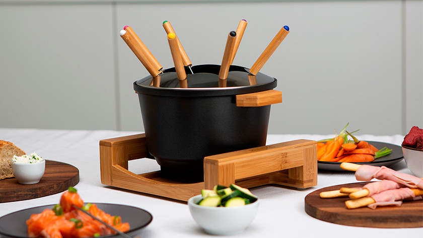 Fondue pot with vegetables and meat