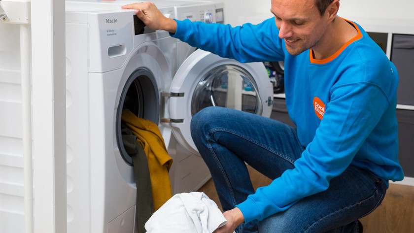 Washing machine with pile of laundry