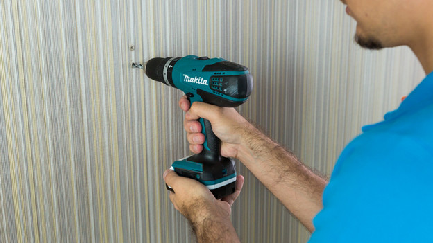 Someone that drills the holes in the wall