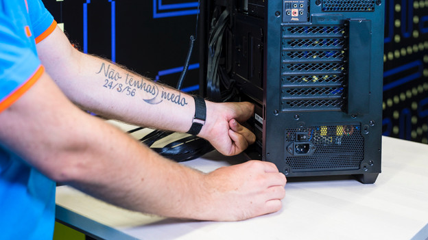 Expert places a computer power supply unit in a home-built PC