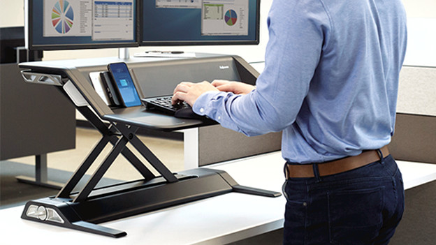 Desk riser for working while standing