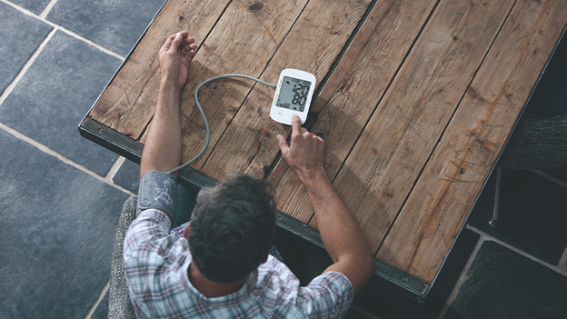 Man with blood pressure monitor