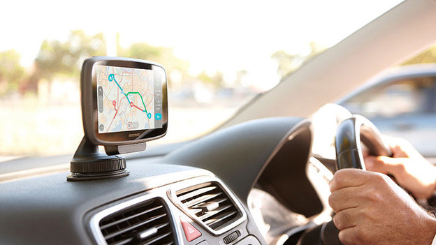 TomTom VIA car navigation dashboard hands on the wheel