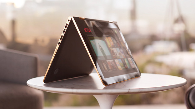 Laptop on table in tent mode with Netflix on the screen.