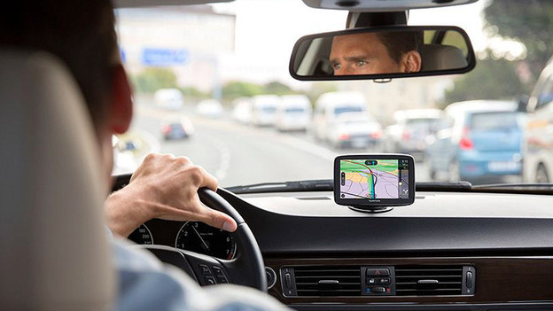 TomTom VIA man drives car with car navigation system