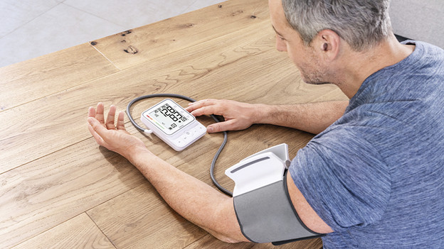 Man with blood pressure monitor