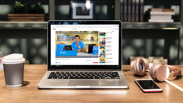 MacBook in coffee bar with Coolblue vlog on YouTube.