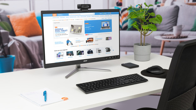 All-in-one PC viewed from the side with keyboard and mouse.