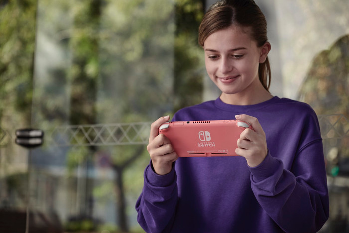 Nintendo Switch Lite Coral + Mario Kart 8 Deluxe Switch product in use
