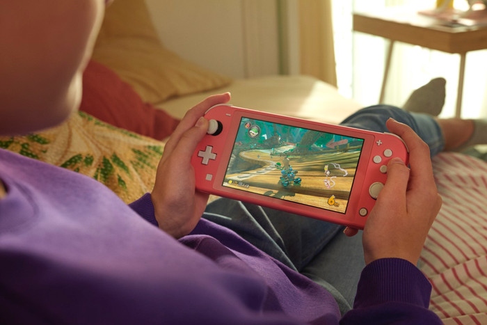 Nintendo Switch Lite Coral + Mario Kart 8 Deluxe Switch product in use