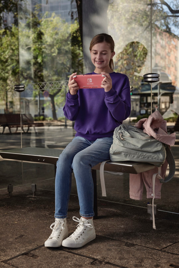 Nintendo Switch Lite Coral + Mario Kart 8 Deluxe Switch product in use