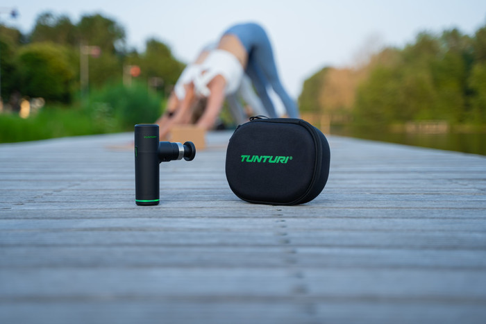 Tunturi Massage Gun Mini + Massage Head Warm and Cool product in use