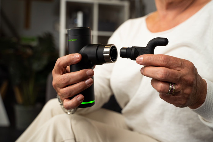 Tunturi Massage Gun Mini + Massage Head Warm and Cool product in use