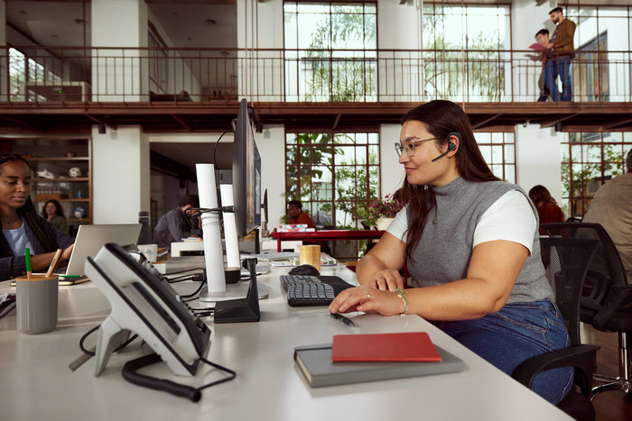 Poly Voyager Legend 50-M UC Bluetooth Headset + Charging Case product in use